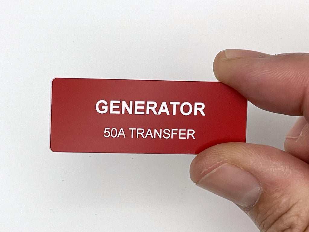 A rectangular red label with white text that reads GENERATOR on the top line and 50A TRANSFER on the bottom line. The label has a smooth finish and is designed for clear identification of electrical equipment and power systems.