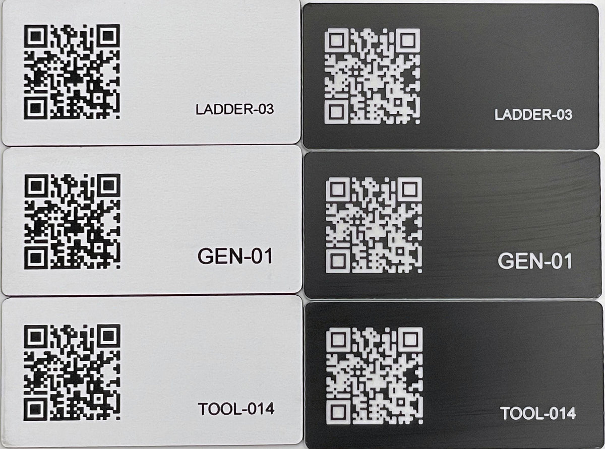 A set of six rectangular engraved identification tags arranged in two columns. Three tags are white with black QR codes and text, and three are black with white QR codes and text. The labels read LADDER-03, GEN-01, and TOOL-014.
