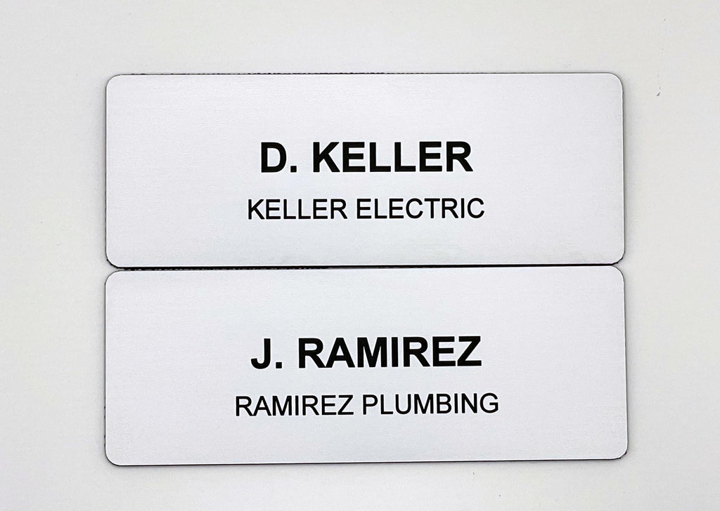 Two rectangular white name badges with rounded corners. The top badge features the black text D. KELLER and KELLER ELECTRIC. The bottom badge features the black text J. RAMIREZ and RAMIREZ PLUMBING. Both badges have a clean, professional design.