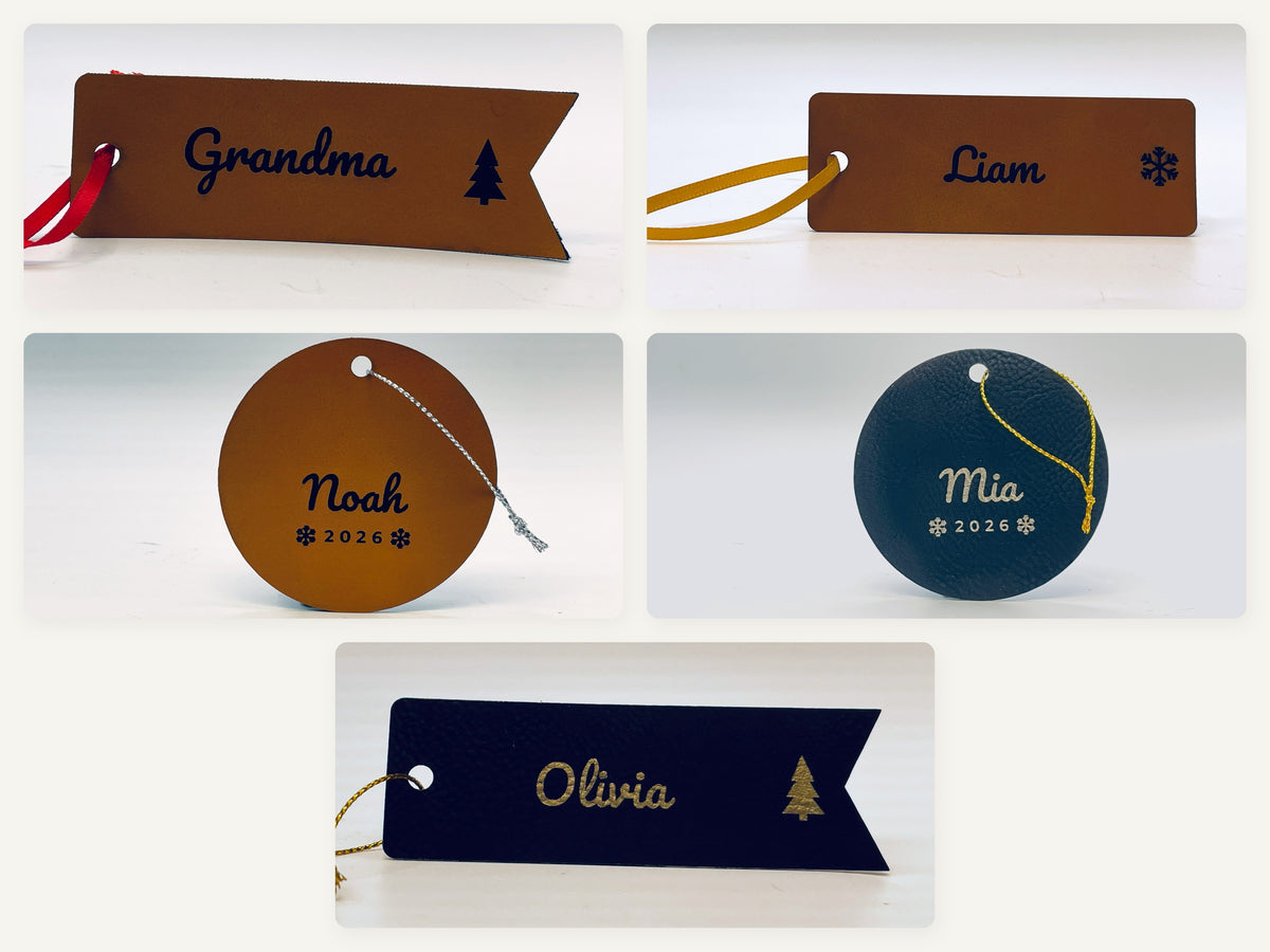 Five Christmas stocking name tags in three shapes and two colors: Grandma on a rawhide flag, Liam on a rawhide tag, Noah on a rawhide round, Mia on a black and gold round and Olivia on a black and gold flag.