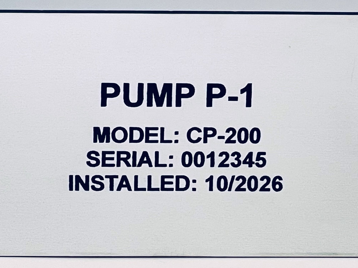 Close view of an engraved data plate: black letters reading PUMP P-1, MODEL: CP-200, SERIAL: 0012345, cut into the white surface.