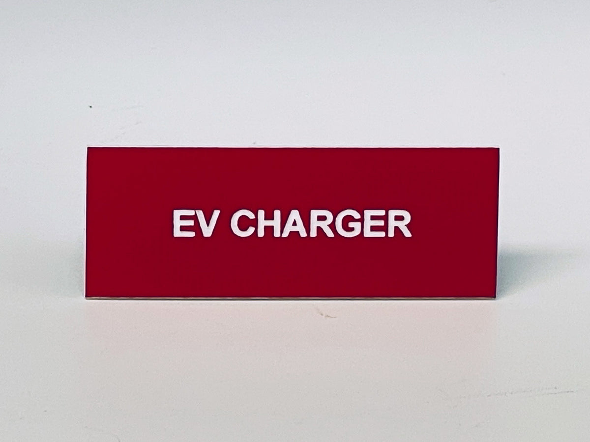 Red engraved label with white letters reading EV CHARGER, the small breaker label.