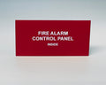 Red engraved placard with white letters reading FIRE ALARM CONTROL PANEL, INSIDE.