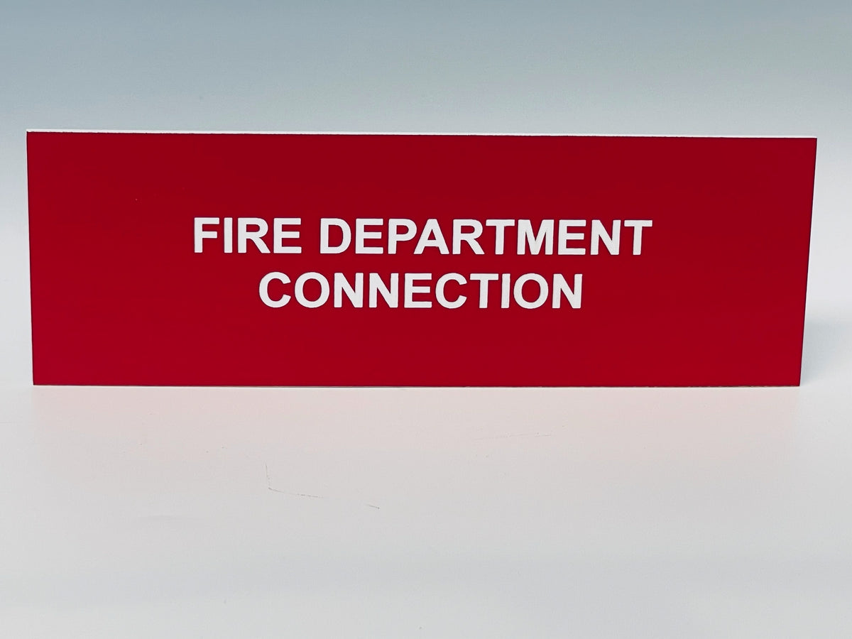 Red engraved placard with white letters reading FIRE DEPARTMENT CONNECTION.