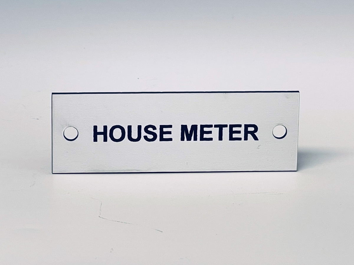 White engraved tag with two screw holes, black letters reading HOUSE METER.