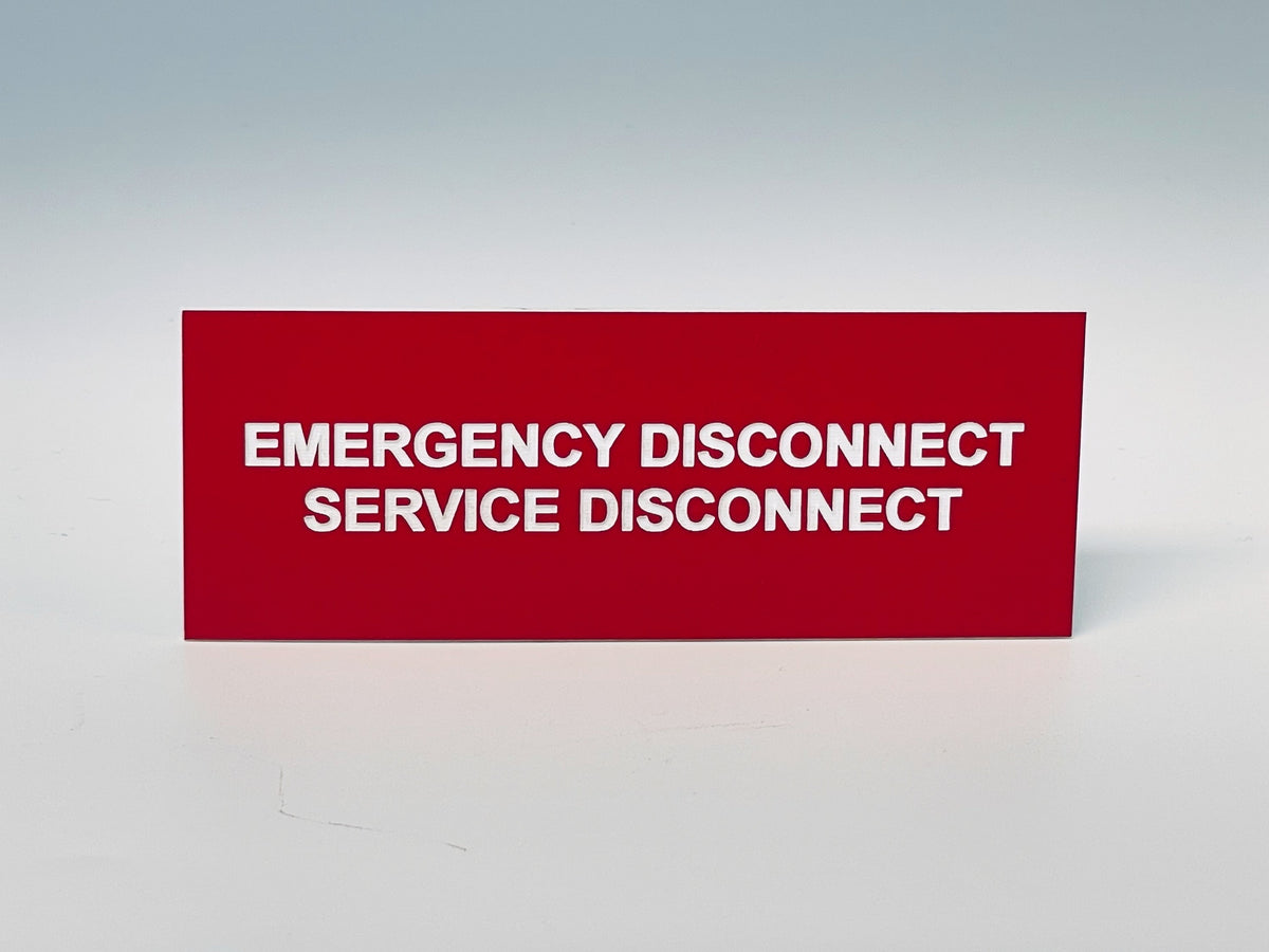 Red engraved label with white letters reading EMERGENCY DISCONNECT, SERVICE DISCONNECT.