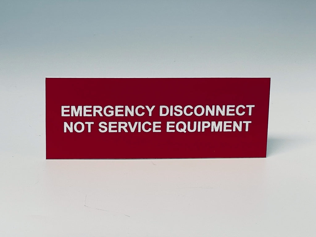 Red engraved label with white letters reading EMERGENCY DISCONNECT, NOT SERVICE EQUIPMENT, the second emergency wording you can choose.