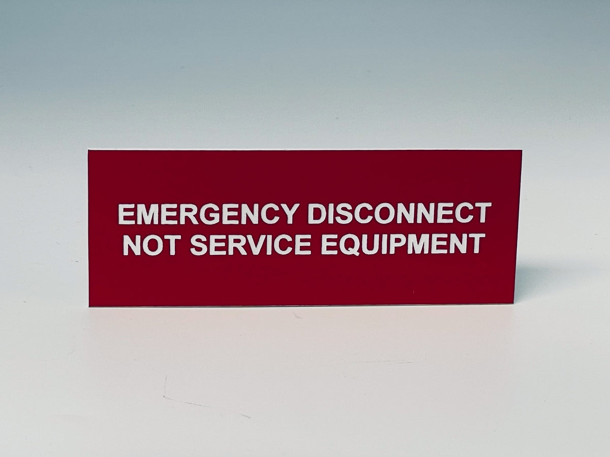Red engraved label with white letters reading EMERGENCY DISCONNECT, NOT SERVICE EQUIPMENT, the second emergency wording you can choose.
