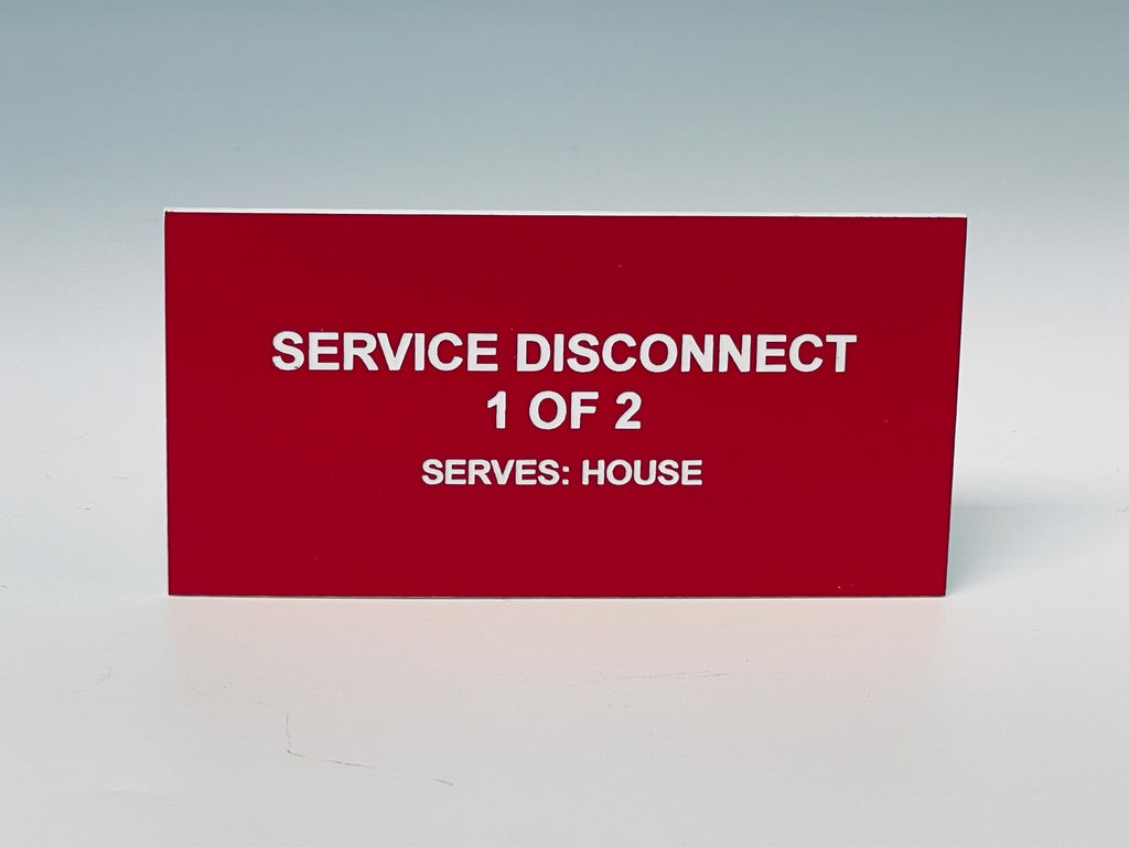 Red engraved label with white letters reading SERVICE DISCONNECT, 1 OF 2, SERVES: HOUSE.