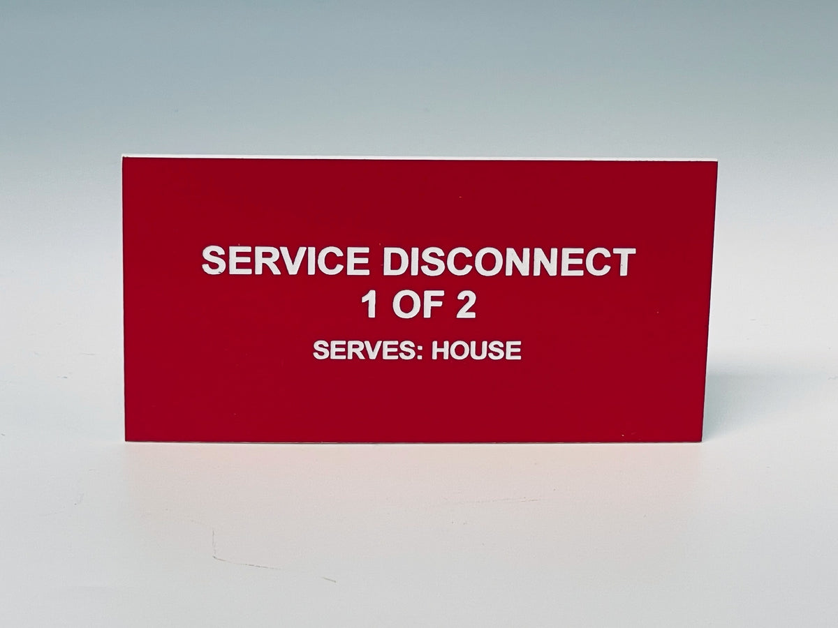 Red engraved label with white letters reading SERVICE DISCONNECT, 1 OF 2, SERVES: HOUSE.