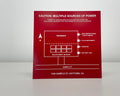 Red engraved solar site-map placard reading CAUTION: MULTIPLE SOURCES OF POWER, with a building diagram.