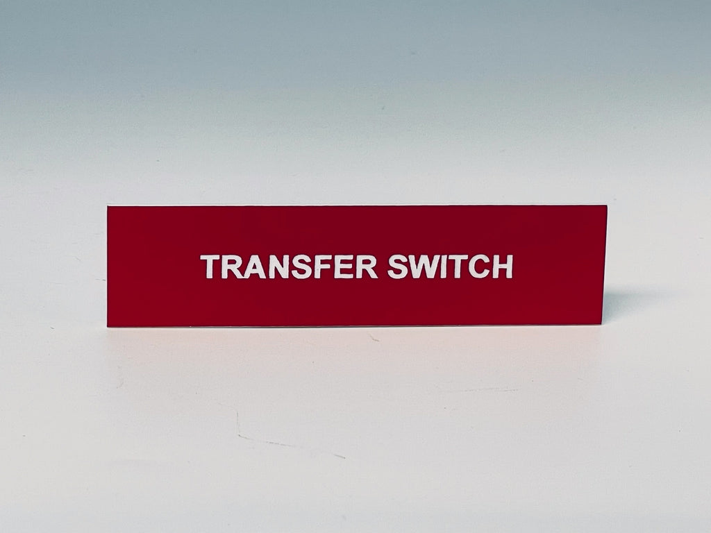 Red engraved label with white letters reading TRANSFER SWITCH.
