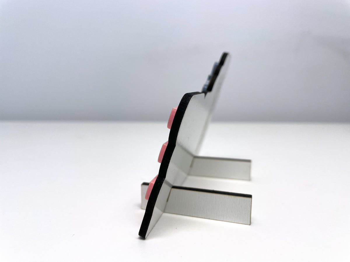 Side view of the Ms. LEE teacher sign, showing the two slide-on feet that hold it leaning back on a desk.