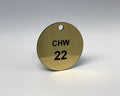 Round brushed gold valve tag engraved CHW 22 in black, with a hole at the top for a chain or S-hook.